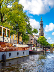 The canal corner between Leiegracht and Prinsengracht canals with the imposing Westerkerk church in the background, Amsterdam, Holland, the Netherlands