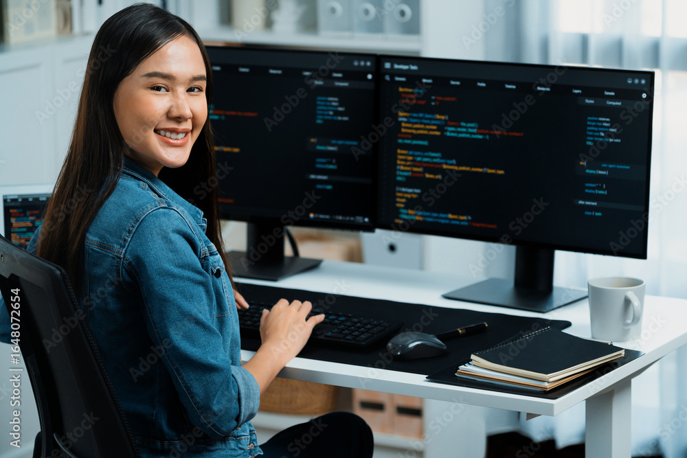 Poster young asian in it developer looking at camera to present with online information on pc with coding p