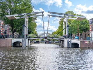One of the several still operating draw bridges in the canal system of Amsterdam at a crossing with the inner Amstel river (Binnenamstel), Holland, the Netherlands