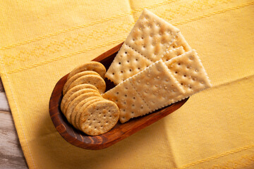 saltine crackers and whole wheat crackers, round and square.