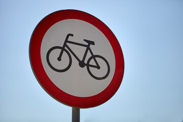 No bicycles sign photo with blue sky in the background