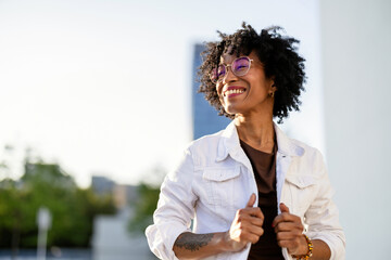 Portrait of a smiling young woman in the city on a sunny day
