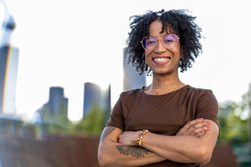 Portrait of a smiling young woman in the city on a sunny day

