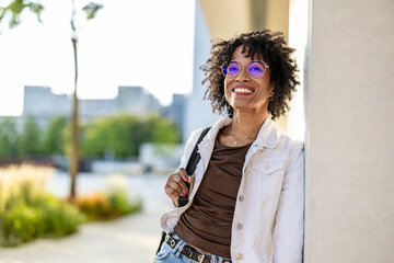 Portrait of a smiling young woman in the city on a sunny day

