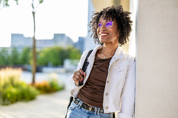 Portrait of a smiling young woman in the city on a sunny day
