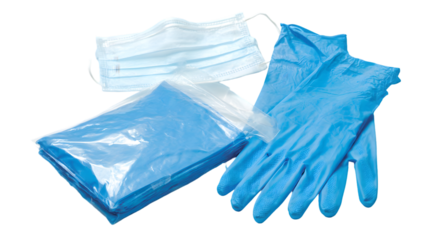 A still life shot showing a surgical mask blue gloves and a folded blue sheet on a plain background