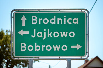 Green road sign showing directions to Brodnica, Jajkowo, and Bobrowo