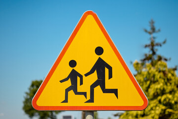 Children crossing warning sign on a sunny day