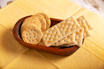 saltine crackers and whole wheat crackers, round and square.