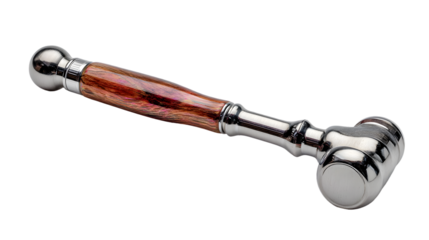 A gavel with a wooden handle and a shiny silver head sitting on a black background in a studio shot
