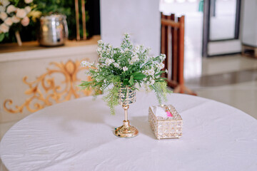 flower vase and tissue holder on the table