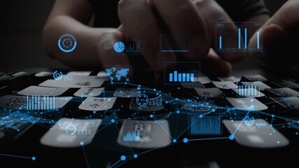 This close-up image features a hand typing on a keyboard, overlaid with digital graphs and data visuals, symbolizing technology and data analysis in a modern workspace. Xenic - Powered by Adobe