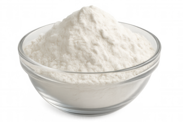 Baking soda cascading over glass bowl rim, spilling against transparent backdrop for culinary visual concept