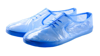 A pair of light blue disposable shoe covers with dark blue soles on a black background surface