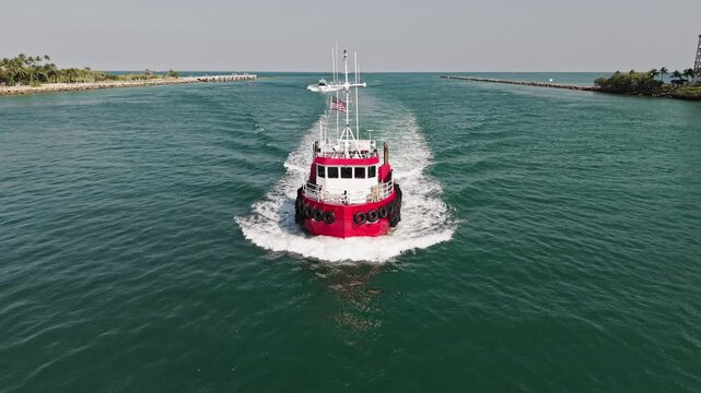 Tugboat sailing at sea top view. Motor boat. Boating and tugging. Tugboat sea transportation. Boat tug at sea. Aerial footage of tow-boat transportation