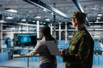 Army specialists implementing artificial intelligence to strengthen military network infrastructure. Military server room colleagues modernizing armed forces by incorporating machine learning