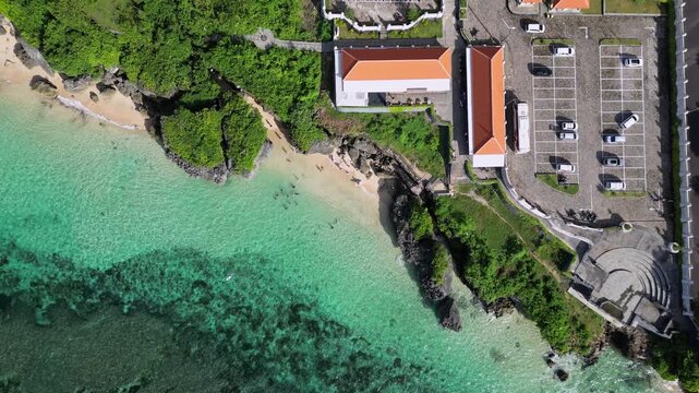 Aerial view of parking area with cars at seaside at sunny day. Geger beach. Nusa Dua. Bali. Indonesia