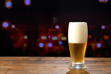 Refreshing beer on a wooden table in a bar