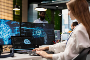 Female engineer developing applications using AI LLM chatbot on multiple devices. Worker doing...