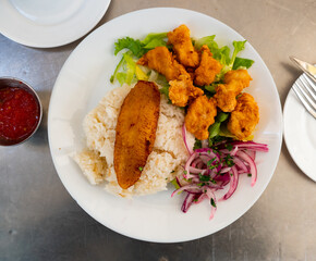 Traditional Latin American dish chicharon. Food is prepared from pieces of fried white sea fish...