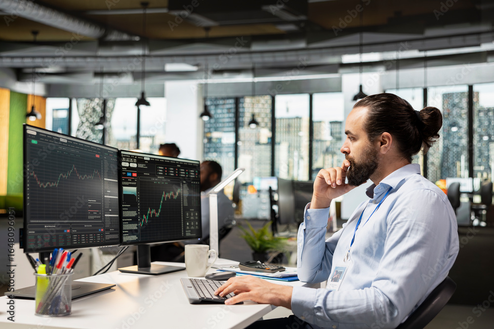 Poster trader in prop firm office analyzing market data and executing trades using trading software interfa