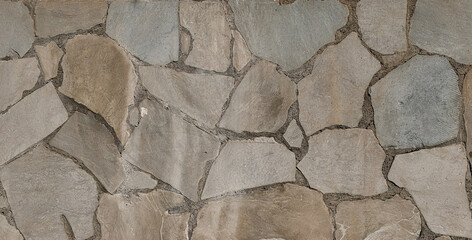 Irregular stone wall texture with visible joints, surface with a natural and rustic finish