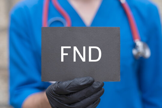 Doctor holding black paper card with acromym: FND. FND Functional Neurological Disorder Medical Concept. Healthcare Brain Diseases Research Treatment Innovation.