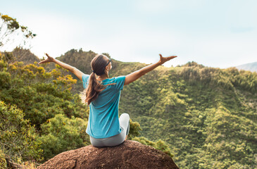Happy woman feeling free joyful in a beautiful mountain nature setting. 
