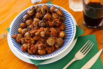 Delicacy snails with minced meat and tomatoes. Mediterranean dish