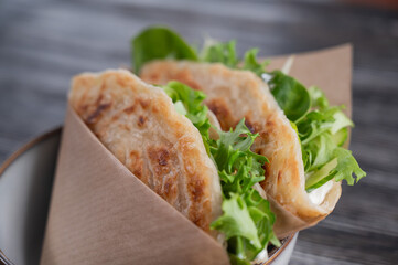Flatbread with greens served in a cafe. 