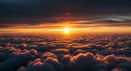 Obraz premium Dramatic sunset above clouds aerial view from airplane window golden hour sky orange pink colors nature landscape atmospheric flight travel