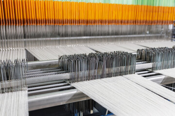 Modern weaving loom with warp yarns, heddles and reed in textile manufacturing