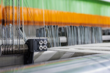 Wool warp tensioner on modern weaving machine macro in textile manufacturing
