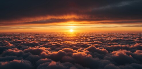 Obraz premium Dramatic sunset above golden clouds viewed from airplane altitude, breathtaking aerial landscape photography for travel content