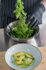 The chef prepares a salad. 