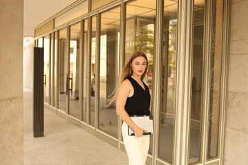  Smiling confident business leader looking at camera and standing outside the office.