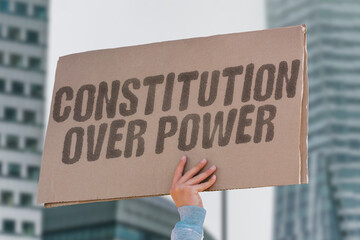“Constitution Over Power — Uphold foundational law” during a civic rally. JUSTICE. RIGHTS....
