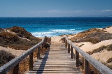 Naklejka premium A wooden path descending to sandy dunes with the ocean far away a perfect summer getaway