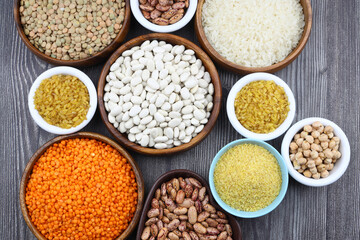 Different type of raw dry legumes composition. White Rice, lentils, red lentils, chickpeas and...