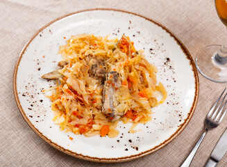 Delicious pork ribs stewed in gravy with sauerkraut closeup