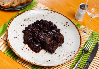 Delicious stewed pork ribs with sliced cabbage served on plate..