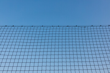 Sport Netting with Grid Pattern on Clear Blue Sky Background