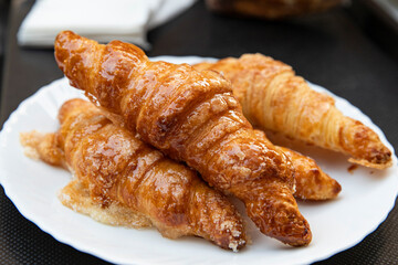 Fragrant croissants with a shiny crust, breakfast