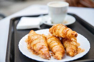 French classics, sweet croissants on a plate, breakfast in a cafe