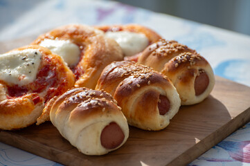 Fresh baked bread, pizza, focaccia or pizzetta with tomatoes, vegetables, sausage and cheese, street food in Palermo, Sicily, Italy, served outdoor for lunch