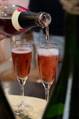 Pouring and tasting of rose or pink cuvee sparkling wine brut, grand reserve, champagne in Ay-Champagne wine making village in Vallee de la Marne, , Champagne region, France