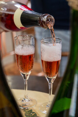 Pouring and tasting of rose or pink cuvee sparkling wine brut, grand reserve, champagne in Ay-Champagne wine making village in Vallee de la Marne, , Champagne region, France