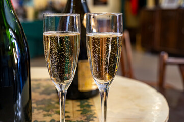 Pouring and tasting of dry sparkling wine brut, grand reserve, champagne in Ay-Champagne wine making village in Vallee de la Marne, , Champagne region, France