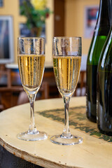 Pouring and tasting of dry sparkling wine brut, grand reserve, champagne in Ay-Champagne wine making village in Vallee de la Marne, , Champagne region, France