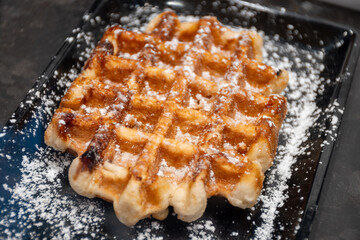 Baked belgian sugar waffles with various toppings, delicious sweet street food in Bruges, Flanders, Belgium